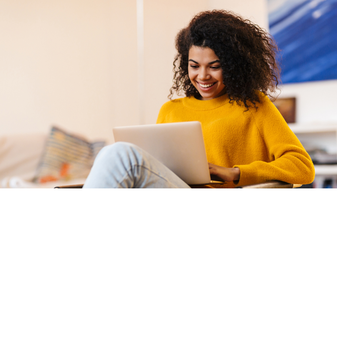 girl smiling down at her laptop