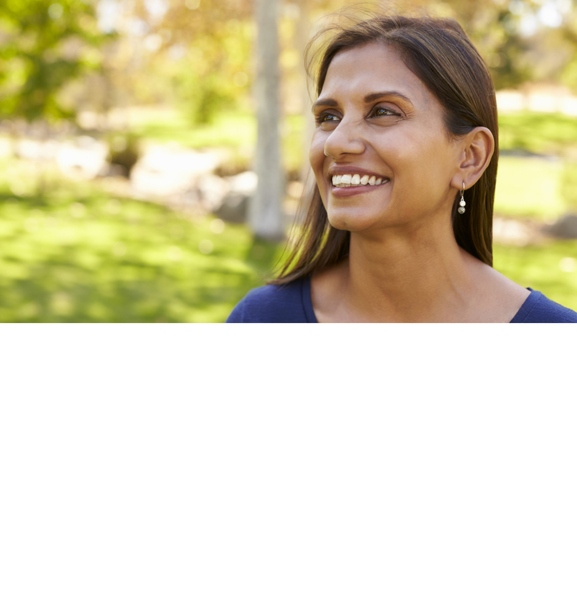 ethnic lady looking up and smiling in nature